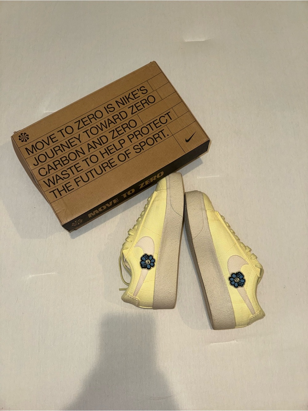 Nike Pale Yellow Low-Top Sneakers with Blue Flower Accent